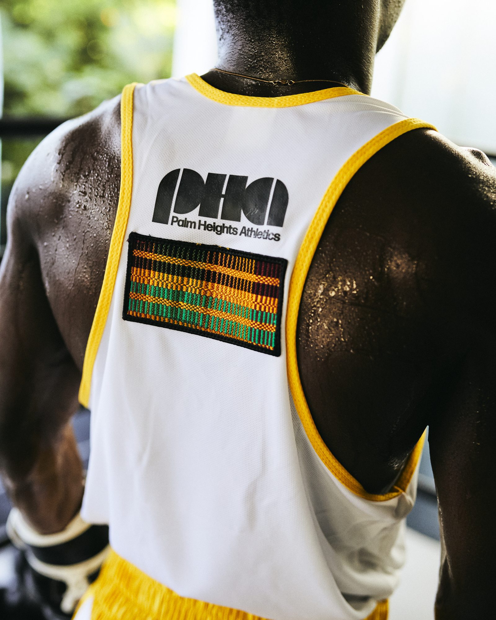 Kente patch on the back of the Palm Heights Athletics vest