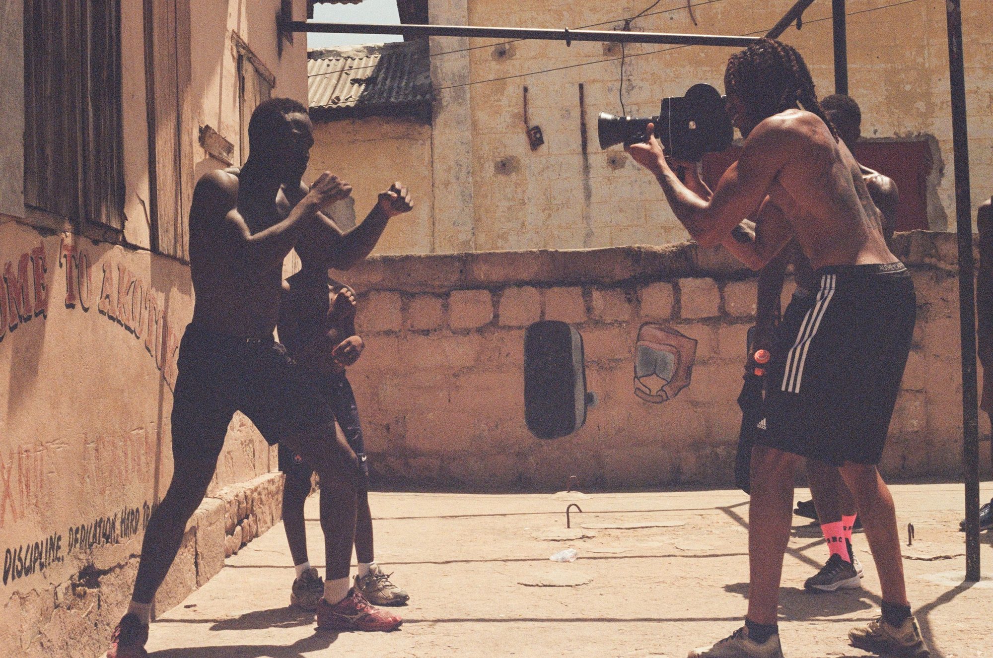 Filming a sparring session on the rooftop. Film photograph by Ludovic Nkoth