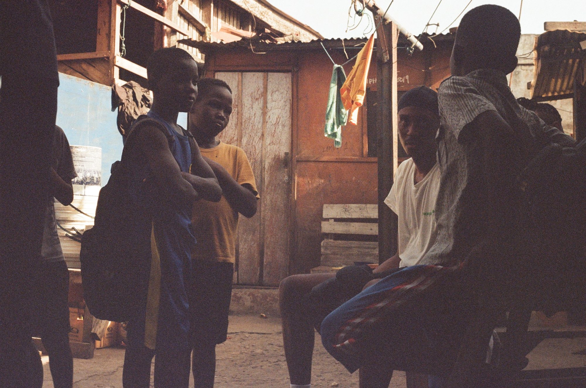 Young fighters at the gym door. Film photograph by Ludovic Nkoth