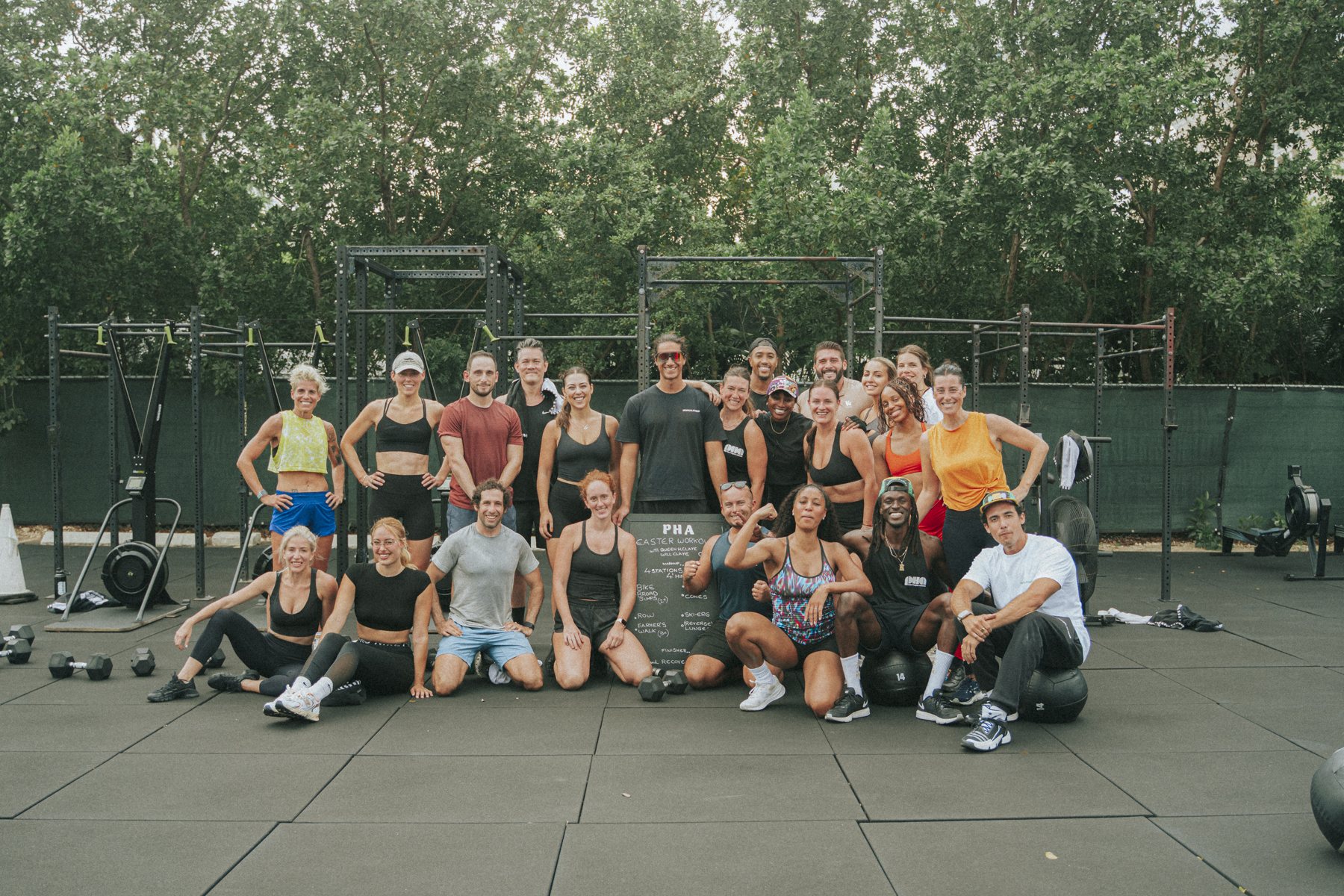 A large group of guests and members after the Palm Heights Athletics Easter workout, gathered around the session board