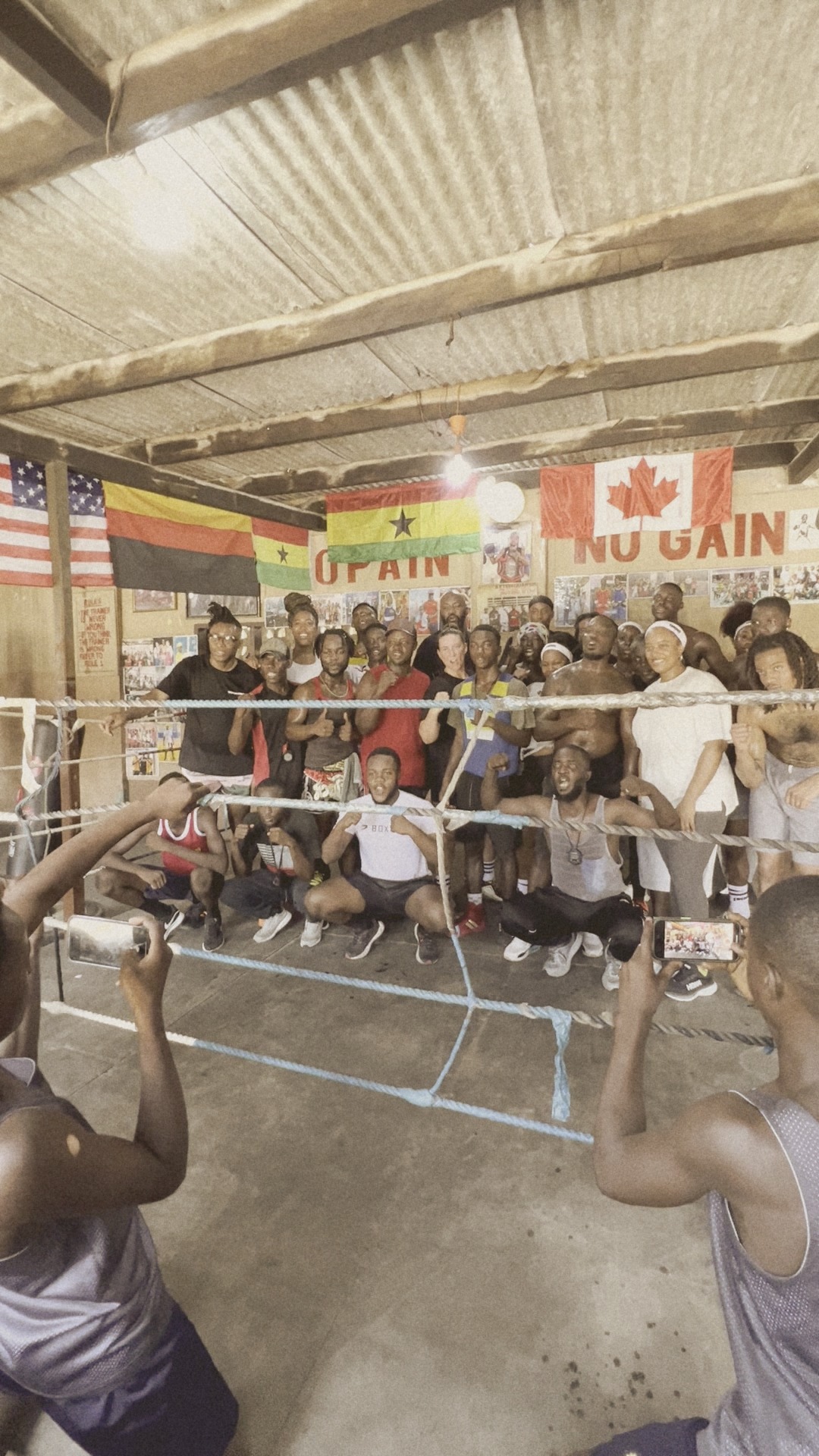 The group with the fighters and coaches around the ring