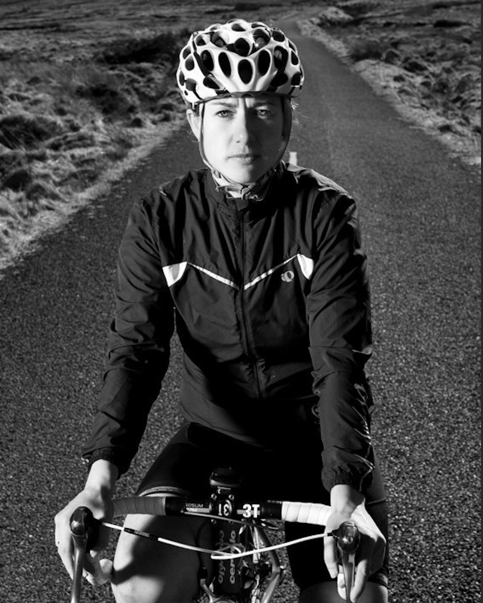 Black and white portrait of Jennifer on her road bike