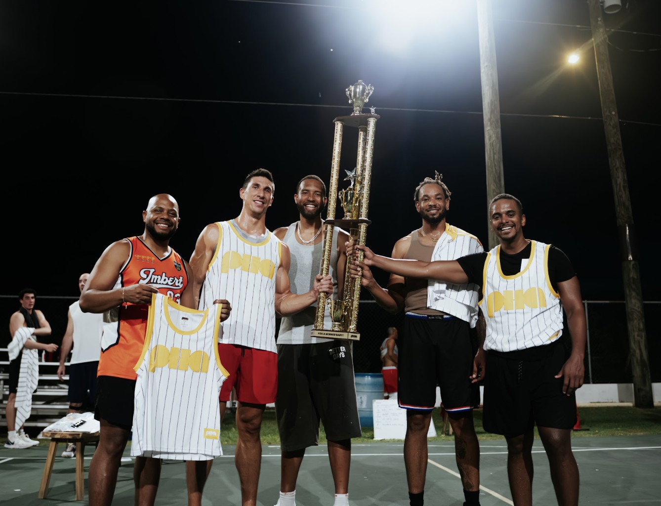 The 3x3 winners with the trophy under the floodlights. Sam Su